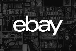 A black and white photograph of an the Rockets and Rascals bike shop in Poole, featuring a large white 'ebay' logo centered across the image.